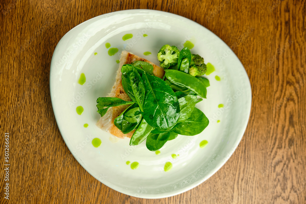 Pike perch fish fillet with spinach leaves Pike perch fish fillet with spinach leaves