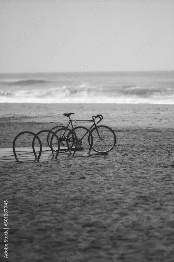Obraz premium bike stands on the beach black and white photo