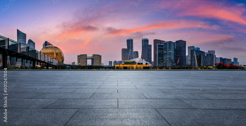 Empty square floor and city skyline with modern commercial buildings in Hangzhou at sunset, China. - obrazy, fototapety, plakaty 