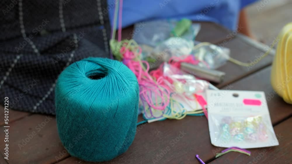 Overview of yellow and blue yarn ball been used to make friendship