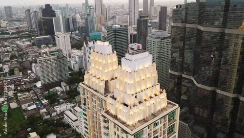 Aerial 4K video flying over the conterporary Bangkok district with scyscrapers