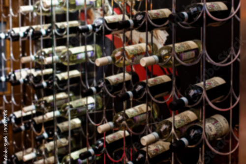 Wallpaper Mural Blurred wine bottles stacked on shelves. Torontodigital.ca