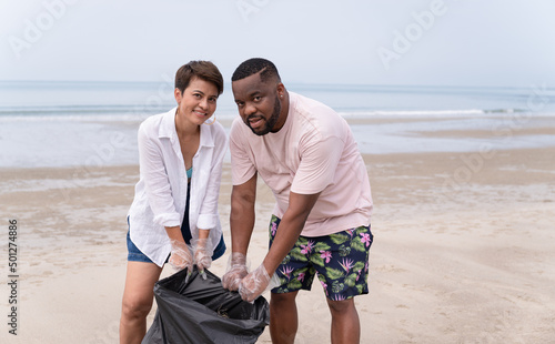 Couple garbage clean up on the beach 