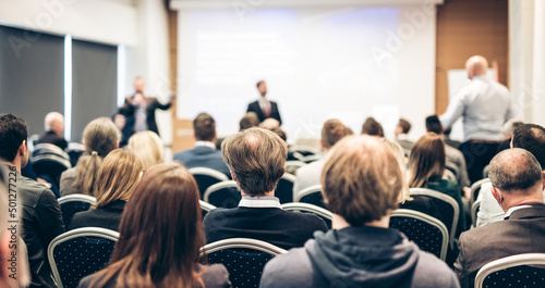 I have a question. Group of business people sitting in conference hall. Businessman raising his arm. Conference and Presentation. Business and Entrepreneurship © kasto