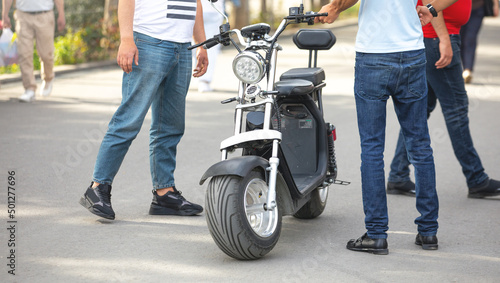 Canvas Print Electric big wheel scooter in the city. For rent