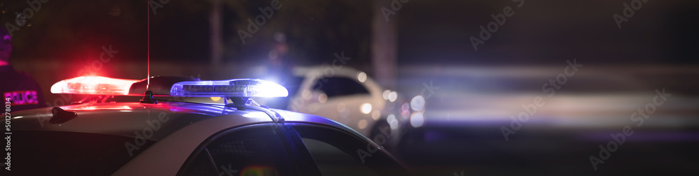 Red and blue light flasher. Police car at night time in the city Red and blue light flasher. Police car at night time in the city