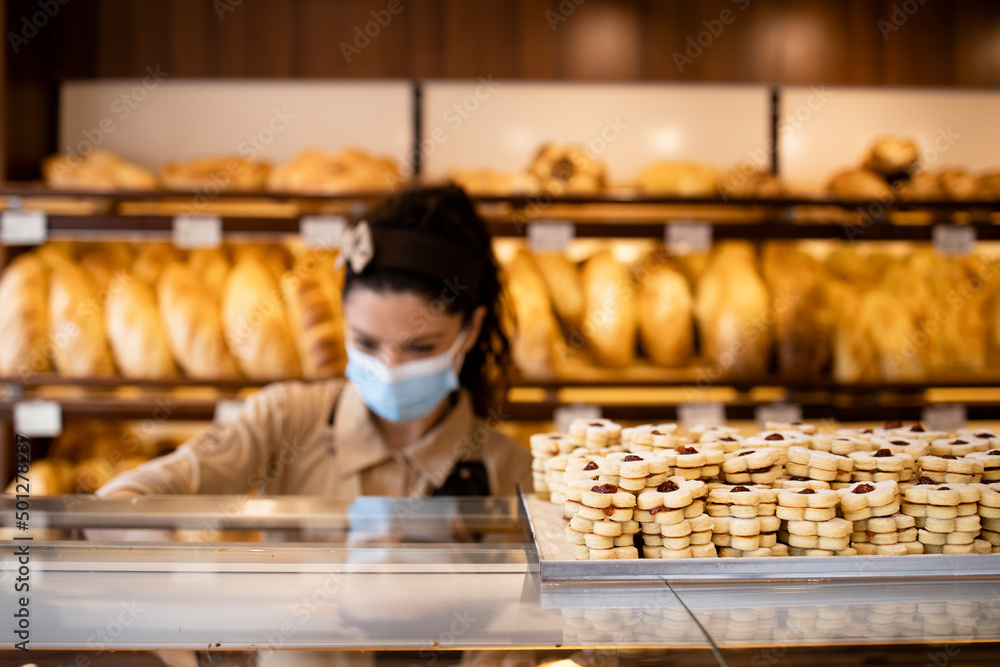 Selling cookies and pastry in bakery shop.