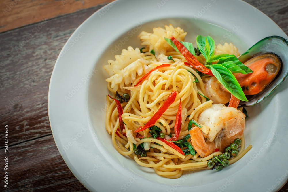 Seafood spaghetti with large shrimp on spaghetti on a plate, ready to serve.