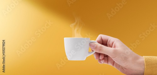 Tableau sur toile Hand holding a cup of coffee