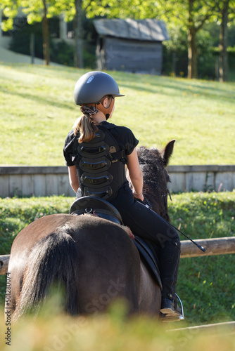 young girl on horseback in an equestrian center © goodluz