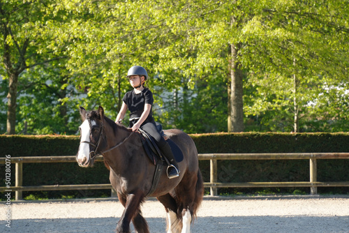 young girl on horseback in an equestrian center