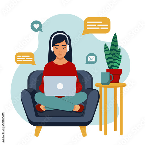 A girl on a chair with a laptop on her lap