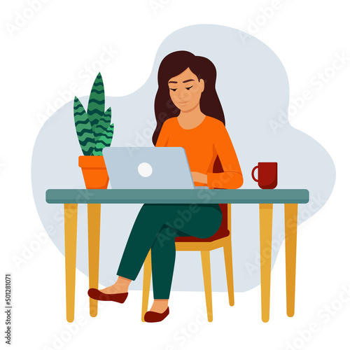 A girl with a laptop at the table