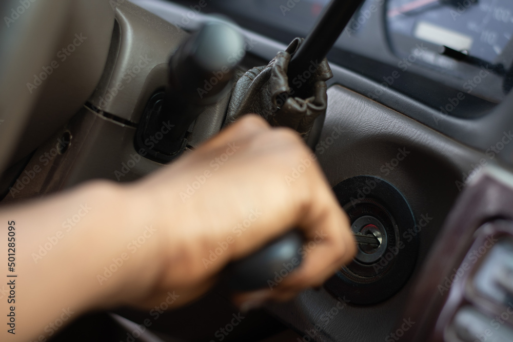 black person putting a key into the car ignition black person putting a key into the car ignition