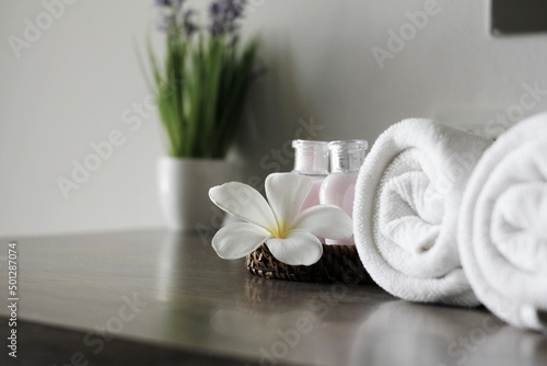 White towel rolls, spa concept, beautiful spa elements on the massage table in the wellness center.