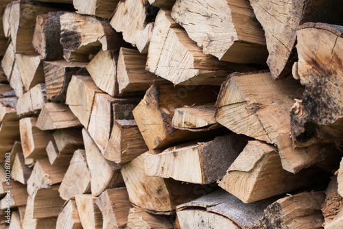 Fresh brown pile of tree stumps, woods structure. Wooden pattern background. Ecological heating, renewable energy sources. Ecological fuel. Sawmill, woodworking industry
chopped firewood