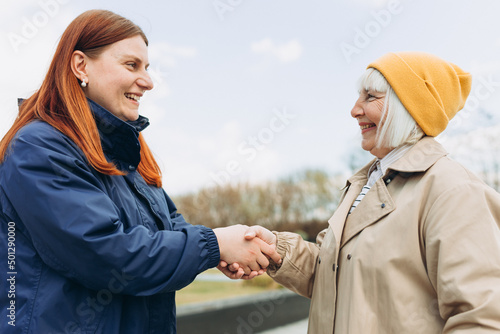 Tableau sur toile Two women friends or female partners meet on sity street