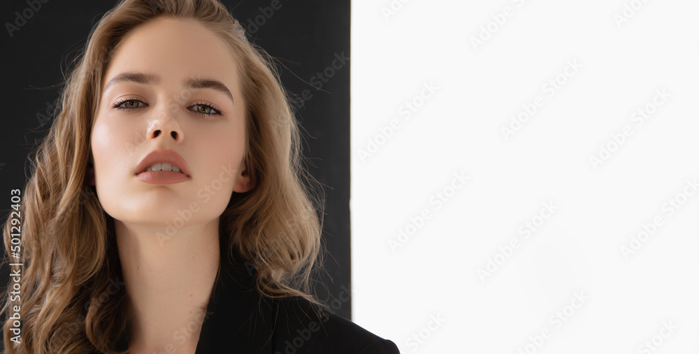 Natural look. Beauty model woman . Model test portrait with young beautiful fashion model posing on grey background. Blond woman in a black blazer . Natural makeup Natural look. Beauty model woman . Model test portrait with young beautiful fashion model posing on grey background. Blond woman in a black blazer . Natural makeup