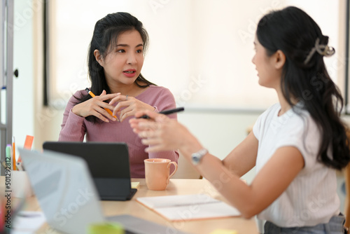 Professional female entrepreneur discussing with her marketing manager
