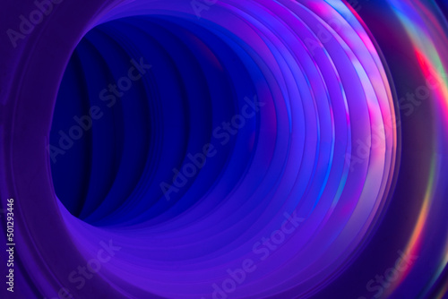 Abstraction  corrugated pipe with circles of rainbow light