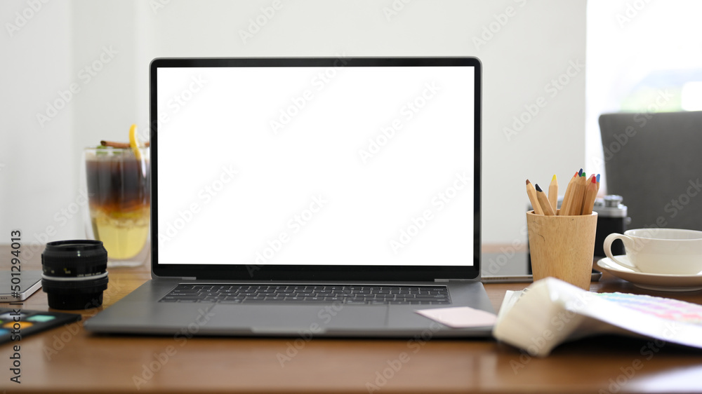 Notebook laptop computer white screen mockup on modern office desk Notebook laptop computer white screen mockup on modern office desk