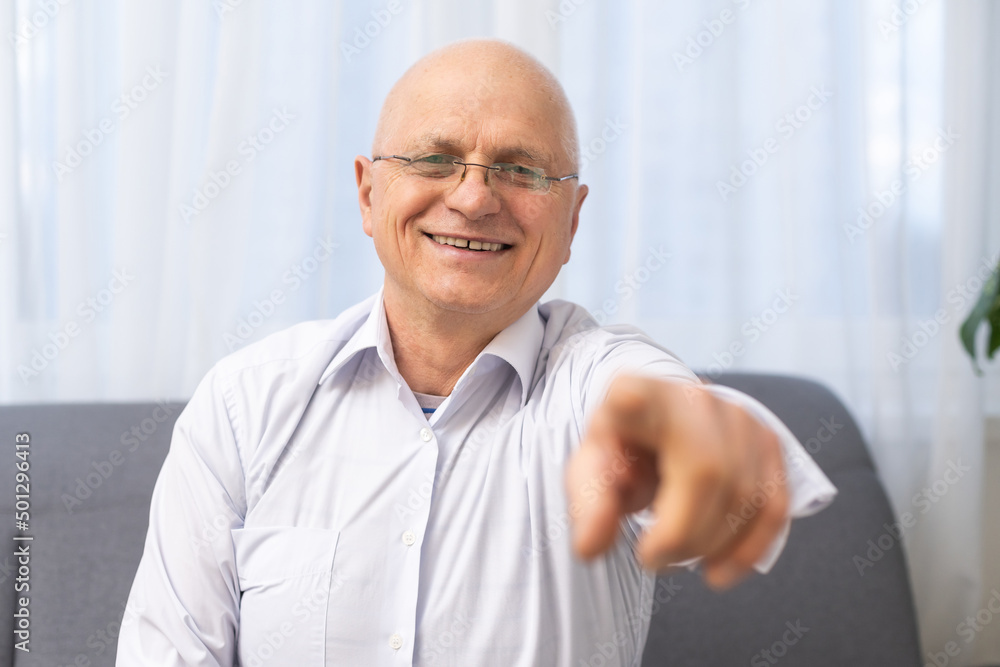 Portrait of happy senior man smiling at home. Old man relaxing on sofa and looking at camera. Portrait of elderly man enjoying retirement. Portrait of happy senior man smiling at home. Old man relaxing on sofa and looking at camera. Portrait of elderly man enjoying retirement.