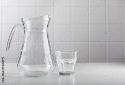 Empty jug and glass of milk