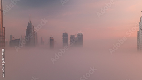 Photography Aerial view morning fog covered Dubai International Financial Centre district ti