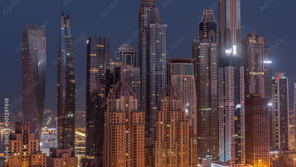 Skyscrapers of Dubai Marina near intersection on Sheikh Zayed Road with highest residential buildings night to day timelapse