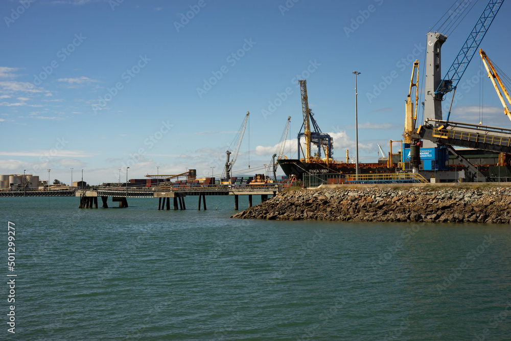 A large freighter tied up to the wharf at Townsville harbour unloading freight.