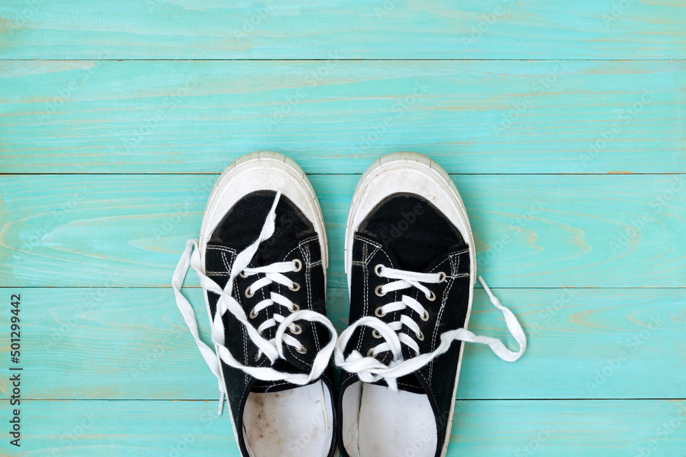 Sneakers on an old blue wooden surface Sneakers on an old blue wooden surface