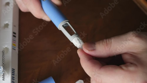obese fat man preparing Semaglutide Ozempic injection to control blood sugar levels