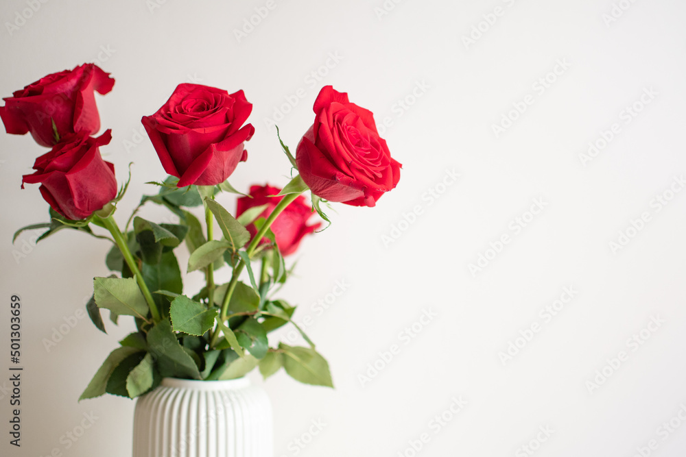 Bouquet of red roses in a white ceramic vase. Bouquet of red roses in a white ceramic vase.
