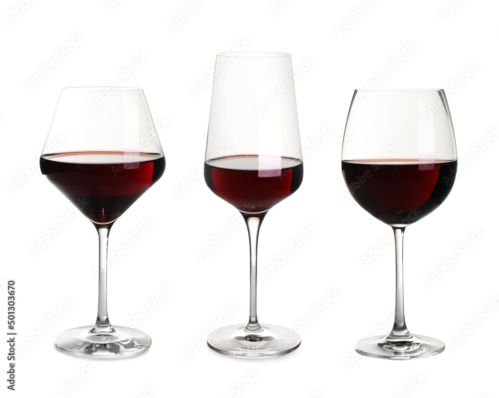 Set with glasses of delicious expensive red wine on white background