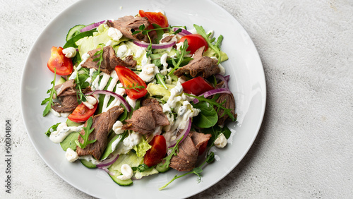 Beef tongue salad with fresh vegetables. Serving food in a restaurant. Photo for the menu