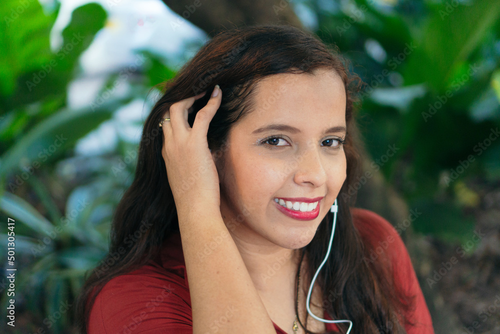 Cheerful Hispanic woman looking at the camera in a park Cheerful Hispanic woman looking at the camera in a park