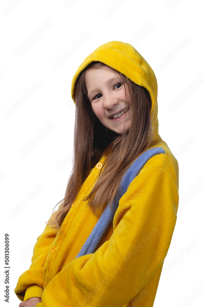 Little cute cheerful girl 10 years old posing in yellow pajamas. Studio photo. Little cute cheerful girl 10 years old posing in yellow pajamas. Studio photo.