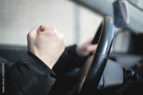 Angry nervous car driver is shaking by his fist close up concept. photo