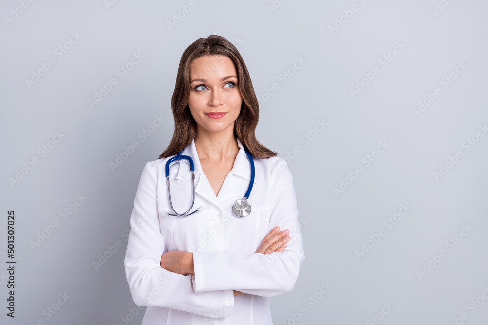 Photo of lady cross arms look empty space think decide new covid protection prescription isolated grey color background Photo of lady cross arms look empty space think decide new covid protection prescription isolated grey color background