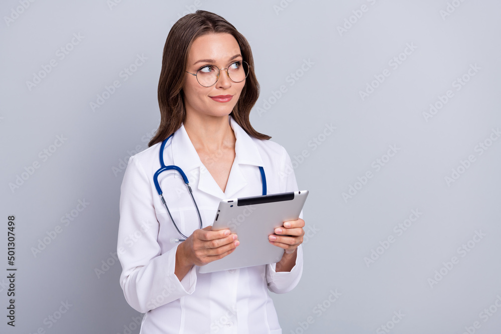 Photo of lady cardiologist hold modern technology device empty space ads vaccine entry isolated grey color background Photo of lady cardiologist hold modern technology device empty space ads vaccine entry isolated grey color background