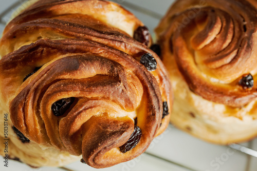 Modern pastry: layered buns with raisins. Shallow depth of field.