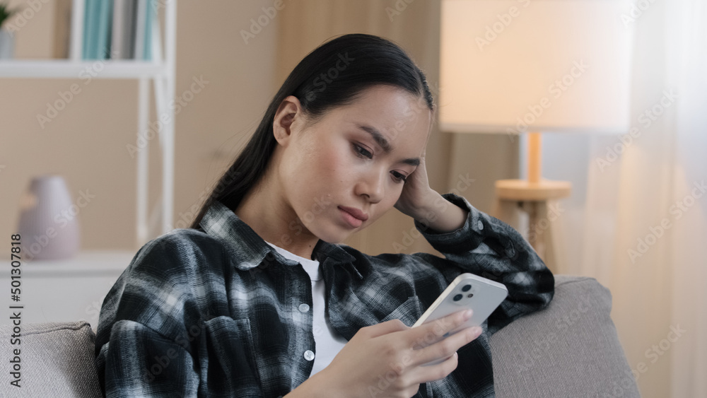 Asian woman has money problem online transfer payment error blocked bank account experiences trouble with e-payment. Female feels angry due lack of funds using mobile phone throwing credit card away Asian woman has money problem online transfer payment error blocked bank account experiences trouble with e-payment. Female feels angry due lack of funds using mobile phone throwing credit card away