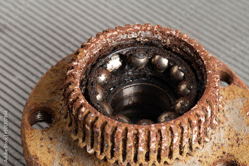 Old rusty wheel hub with a broken bearing. Bearing jamming. Automotive Part, close-up. photo
