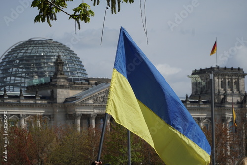 Ukrainian flag on background of Reichstag Berlin