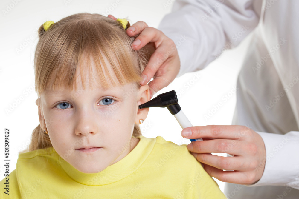 Doctor ENT doctor conducts an otoscopy with a device, closeup