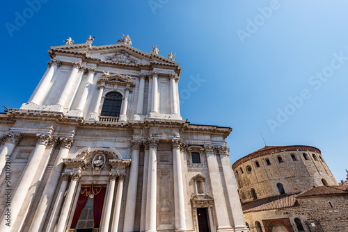 Brescia downtown. New and old Cathedral of Santa Maria Assunta (Duomo Nuovo and Duomo Vecchio) in late Baroque and Romanesque style. Cathedral square or Paolo VI square. Lombardy, Italy, Europe.