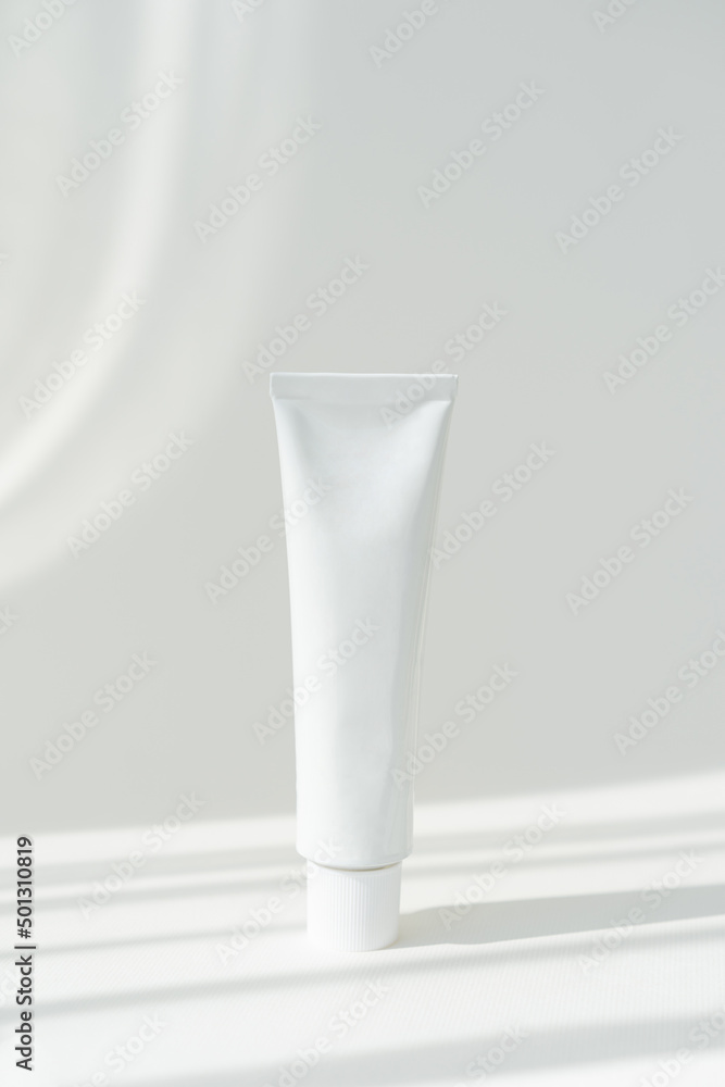 White cream tube cosmetics container mockup on white background. Beauty and medicine mockup with shadows. Minimalist modern mockup White cream tube cosmetics container mockup on white background. Beauty and medicine mockup with shadows. Minimalist modern mockup