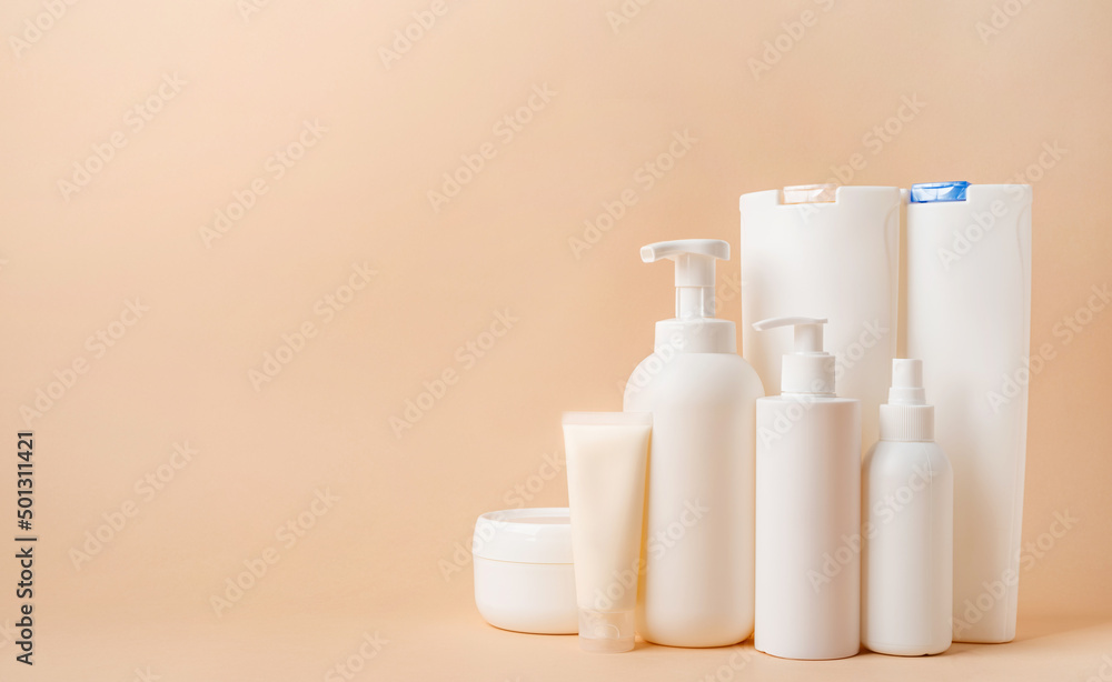 Group of white blank packaging tubes and containers for cosmetics on beige natural color background, mockup design, eco friendly Group of white blank packaging tubes and containers for cosmetics on beige natural color background, mockup design, eco friendly