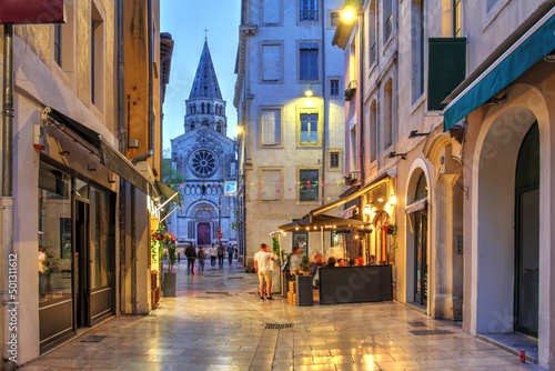 Fototapeta Naklejka Na Ścianę i Meble -  Rue de la Madelaine looking towards Eglise St-Paul in Nîmes, France