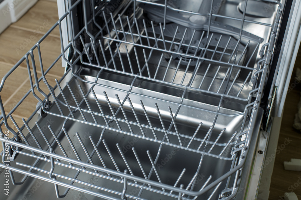 open dishwasher. racks and dishwasher containers.